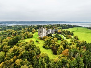 Autumn colours over Penrhyn Castle and Garden from a drone, Llandygai, Bangor, Gwynedd, North