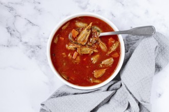French shrimp bisque soup, on a marble table, close-up, no people