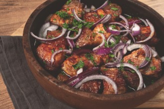 Fried meat, pork kebab, ketsi in a clay pan, with red onions and herbs, homemade, no people
