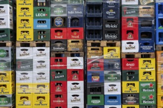 Empty beverage crates, from various manufacturers, bottling, types, stacked at a restaurant, for