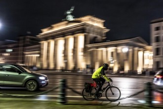 Cyclists, evening traffic on Ebertstraße, on March 18, at Brandenburg Gate, Berlin, Germany