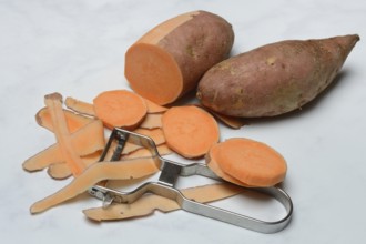 Sweet potatoes with potato peeler, potato slices, partially peeled, Ipomoea batatas