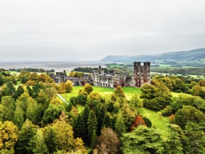 Autumn colours over Penrhyn Castle and Garden from a drone, Llandygai, Bangor, Gwynedd, North