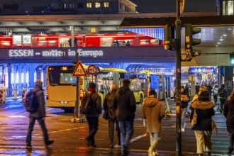 The main train station in Essen, blue illuminated underpass, bus station, am Europaplatz, train on