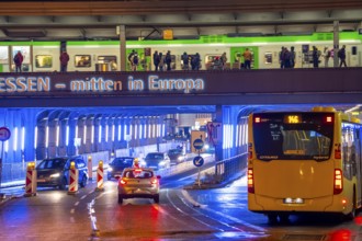 The main train station in Essen, blue illuminated underpass, bus station, am Europaplatz, train on