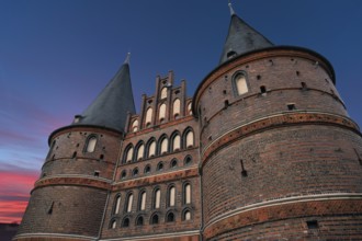 Holstentor, historic city gate from 1478, evening sky, Holstentorplatz, Hanseatic City of Lübeck,