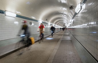 Interior view, pedestrians and cyclists crossing tunnel, mopping effect, movement, tube, historic