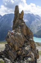 Crocodile rock formation, mountaineer on rope bridge in the Crocodile Mountain Lake via ferrata on