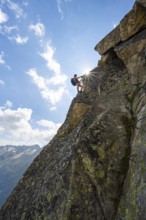 Female mountaineer on steep rock face on the secured via ferrata Krokodil-Bergsee am
