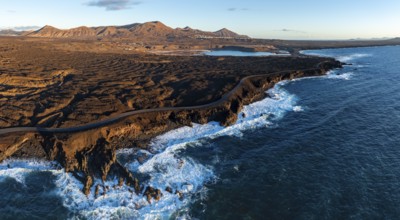 Coast with lava fields, volcanic landscape near Los Hervideros, in the evening light, aerial view,