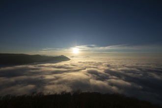 Sunset over the sea of fog from Beurener Fels to Hohenneuffen Castle, Swabian Alb,