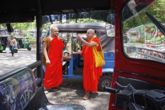 Buddhist monks talking near a tuk-tuk, Kandy, Sri Lanka
