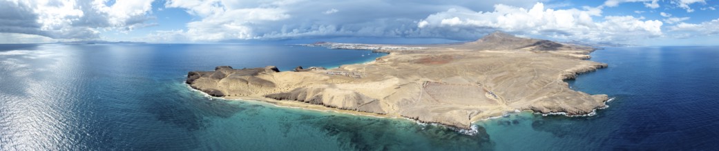 Headland and blue sea, coastal landscape, arid landscape of Los Ajaches Natural Park, aerial view,