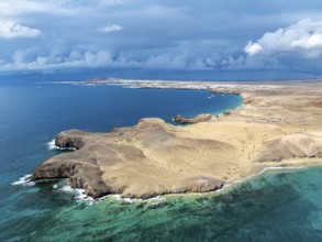 Coast with Playa de Papagayo beach and Playa Caleta del Congrio and blue sea, dry landscape of Los
