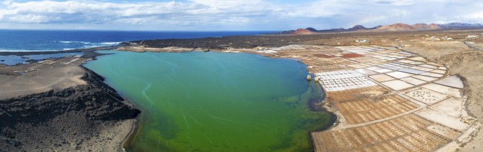 Salt mining plant, Salinas de Janubio with green Laguna de Janubio, near Yaiza, aerial view,