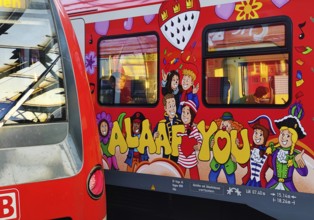 Central Station early in the morning with regional express and S-Bahn with carnival design,