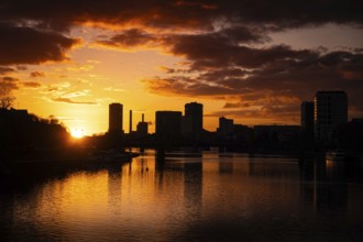The sun sets behind the Main and Frankfurt Westhafen Tower, Alte Brücke, Frankfurt am Main, Hesse,
