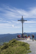 Summit cross with tourists, Brauneck 1555m, Bavarian Prealps, Isarwinkel, Lenggries, Upper Bavaria,