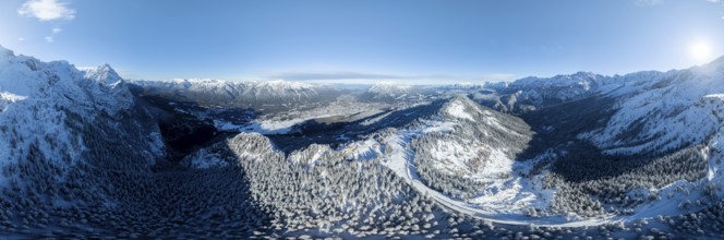Wonderful winter landscape with Zugspitze, blue sky and snow, mountains and mountain valley, aerial