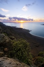 View from steep cliffs to sea and coast with sun stars, Mirador del Porrito viewpoint at sunset,