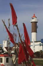 Timmendorf lighthouse on the island of Poel on the Baltic Sea, rigging and flags from a boat in the
