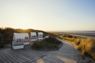 Beach chairs in the dunes and blue sky in winter, sunset, Spiekeroog, East Frisian Islands, Lower