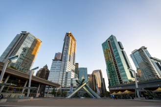 Olympic Cauldron Statue, Jack Poole Plaza Square, skyscrapers on the promenade at sunset, Coal