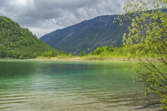 Landscape of Lake Offensee after rain when the sun comes through the clouds in spring,