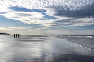 Walkers on the Wadden Sea near the East Frisian island of Spiekeroog, west of the North Sea island,