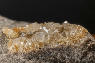Translucent crystals shimmer in granite rocks. The discovery takes place in summer in a quiet,