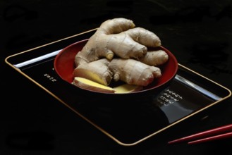 Ginger, ginger root in tea bowl, Zingiber officinale, tea preparation