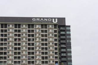 Exterior façade of a residential high-rise building of Condo U (a brand or series name of the Thai