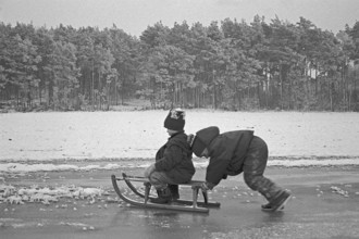 Children ride sledges on ice rink, Bleckede, Lower Saxony, Germany, January 04, 1995, vintage,