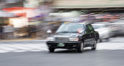 Black taxi driving, motion blur, long exposure, Shubuya Crossing, Shibuya, Tokyo, Japan