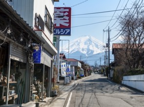 Street scene in a residential area, residential buildings and power lines, view of Mt. Fuji,
