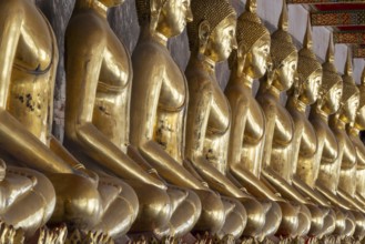 Gilded Buddha statues (Bhumispara mudra: Buddha Gautama at the moment of enlightenment), Wat Suthat