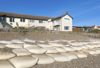 For Sale estate agent signs outside houses at risk of coastal erosion, Thorpeness, Suffolk, North