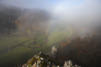Autumn landscape with rising fog over the Grosse Lauter river loop in Lautertal at sunrise. View