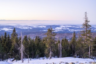 View from Mount Lusen over the hills of the bavarian forest at sunrise in winter, Bavaria, Germany