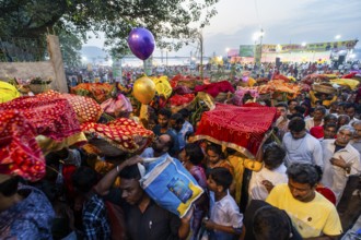 Hindu devotees gather on the banks of the Brahmaputra River to offer prayers to the Sun God on the
