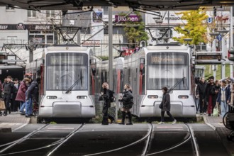 Pedestrians cross the tram tracks, at Düsseldorf-Bilk station, junction of S-Bahn, subway, tram,