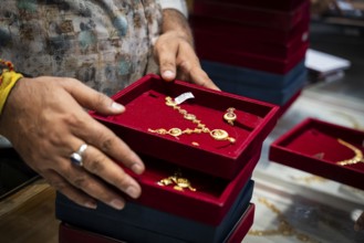 Customers purchase Gold jewelry at a store on the occasion of the festival of Dhanteras, in