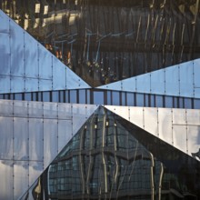 Cube Berlin, cube-shaped office building with folded glass façade reflecting the surroundings,