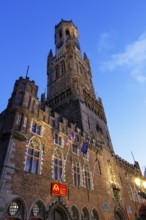 Illuminated Belfry in the historic city centre of Bruges in the evening light, Belfort and City