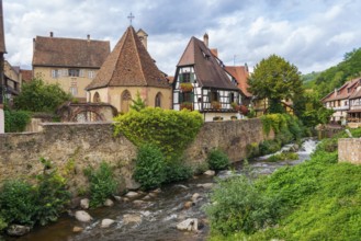 Picturesque Kaysersberg with half-timbered houses on the Weiss river in the old town centre