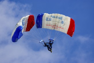 Two parachutists during an aerial acrobatic performance as part of an air show at the Rossfeld in