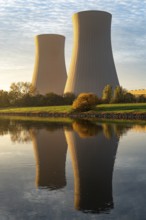 The cooling towers of the Grohnde nuclear power plant in the morning light reflected in the Weser,