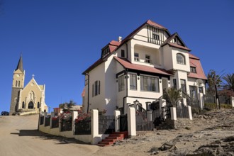 Colonial house facade in the Kirchstraße, in the background the rock church, Lüderitz, Karas
