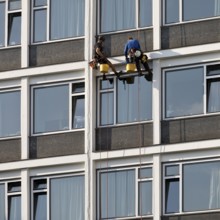 Two male glass cleaners abseiling down the hotel façade to clean windows, aletto Hotel Kudamm,