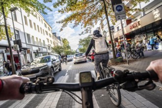 Cycling in the city, city centre road, cycle lane, two-wheeled traffic has priority, 30 km/h zone,